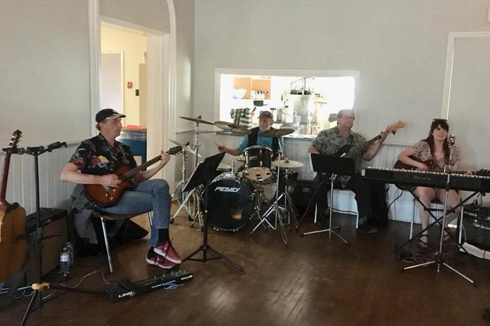 A band of local musicians (Ken Tuck,  Mac Palmer, and Tom Batten), pictured with musical director Bethany Brown, will perform music from Pink Floyd during the production. (Photo: Ida Brown)