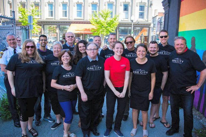 Representatives of the Peterborough DBIA, the Warming Room, the City of Peterborough, and other partners at the May 29, 2018 announcement of "One City Peterborough", a two-pronged pilot program running over the summer that will see vulnerable people hired to help clean the streets of downtown Peterborough and two full-time outreach workers to assist people downtown, particularly those facing homelessness, social exclusion, and mental health issues. (Photo: Peterborough DBIA)