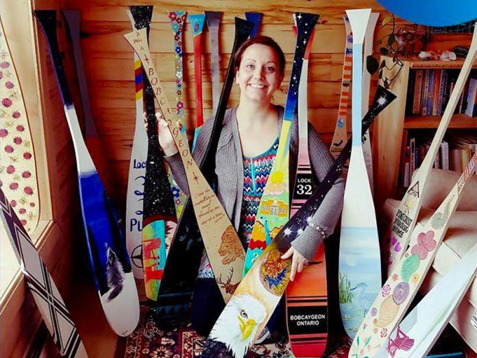 Some of the 70 uniquely painted wooden canoe paddles that will soon be showcased on poles on the main streets of Bobcayeon, as part of the "Vibrant Village" efforts organized by Impact 32, a volunteer steering committee made up of local business owners and community organizers in Bobcaygeon. (Photo: Kawartha Mediums)