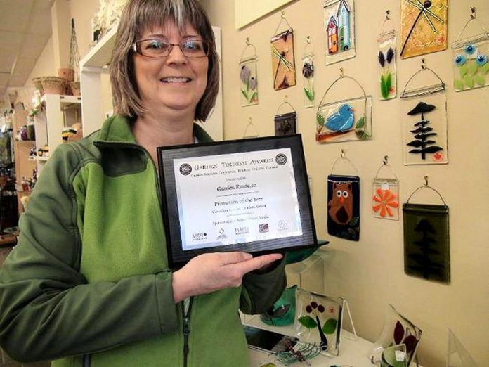 Brenda Ibey, owner of The Avant-Garden Shop, in 2013 displaying the Promotion of the Year award for GardenRoute.ca from the National Garden Tourism Conference. (Photo courtesy of Peterborough and Area Garden Route)