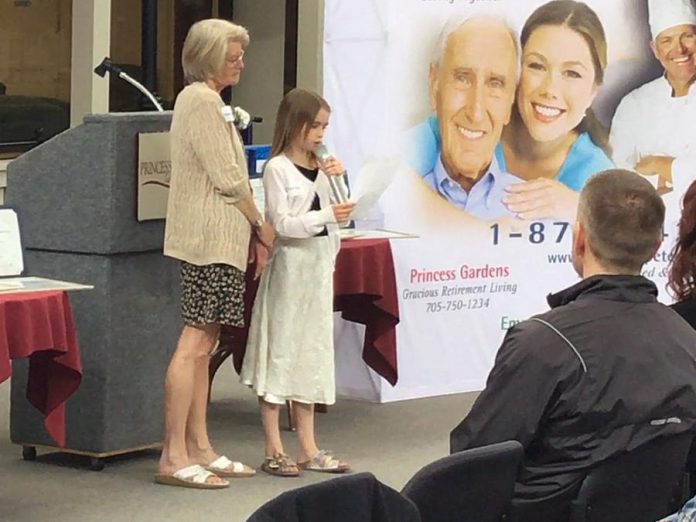 Grade 3 student Olivia Kielec shares her story about her grandmother Dawn Kielec, who received the primary level Grandparent of the Year Award. (Photo: Dean Ostrander)