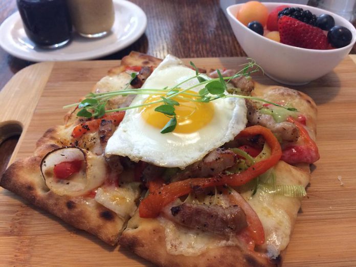 The Monaghan Café in Peterborough is under new ownership. A new menu offers fresh new options like the Sunny Up Pizza, a breakfast pizza with fresh herbs and a sunny-side up egg. Food is made from scratch and served with a bowl of fruit and homemade peanut butter, jam, and ketchup. (Photo: Eva Fisher / kawarthaNOW.com)