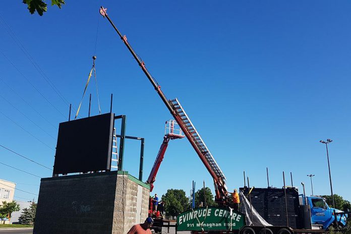 A crew installing two Movingmedia digital billboards at the Evinrude Centre in Peterborough. (Photo courtesy of Movingmedia)