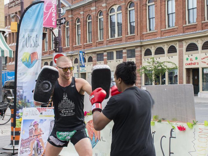 Mike Doherty and Nathanial Kumarasamy of Dohjo Muay Thai show off their skills at the corner of Charlotte and George streets during the June 20th media launch for this year's Peterborough Pulse. The one-day event on July 21st will feature a range of activities, art and music, food, and more. (Photo courtesy of Peterborough Downtown Business Improvement Area)