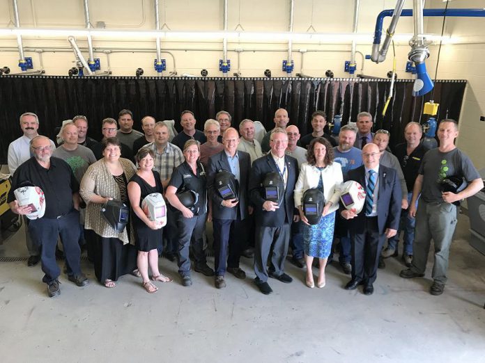 Attendees at the June 26, 2018 media conference celebrating the new $650,000 investment in the Peterborough Victoria Northumberland and Clarington (PVNC) Catholic District School Board's welding program. PVNC director of Education Michael Nasello (pictured in the front row, far right) praised the announcement as a significant advantage for students to receive much-in-demand welding skills while still attending high school. (Photo courtesy of Galen Eagle / PVNC)