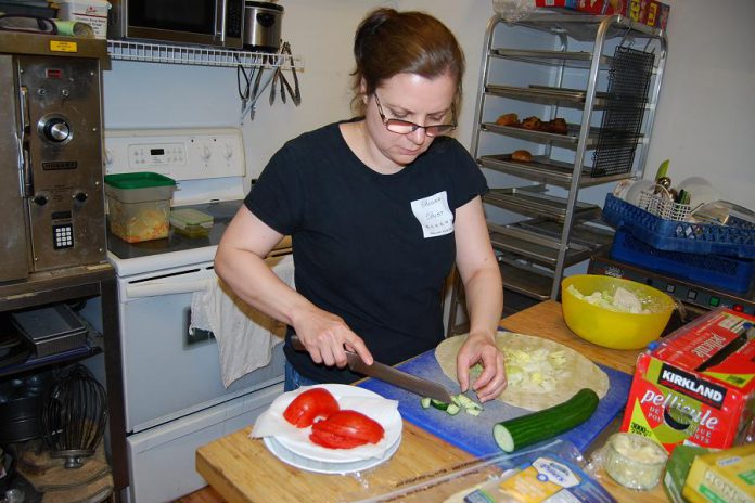 Sugar Dust Bakery & Cafe co-owner Carmela Mango at work in the kitchen. In addition to ice cream, crepes, coffee, and sweets, the restaurant offers a lunch menu with items like Peameal on a Kaiser, Roast Beef on a Kaiser with Coleslaw and Potato Salad, Mediterranean wrap, Strawberry Fields Salad, Cremini mushroom soup, and more. (Photo: April Potter / kawarthaNOW.com)