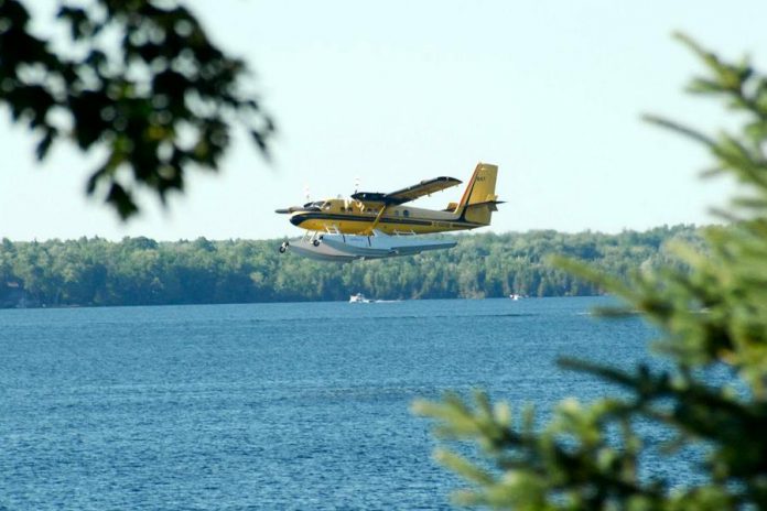 The water bomber comes in for a landing on Balsam Lake to scoop up water from the lake. (Photo courtesy of Dean Nighswander)