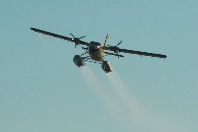 The water bomber finishing its run after dropping a load of water. (Photo courtesy of Dean Nighswander)