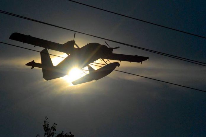 The De Havilland DHC-6-300 Twin Otter water bomber silhouetted against the sun.  (Photo courtesy of Dean Nighswander)