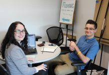Young entrepreneur Dylan Trepanier of Alexander Optical (right) spent his summer in The Cube at the Innovation Cluster in the Slingshot program developing his business plan for an on-demand mobile eye examination clinic. He won $1,000 after pitching his idea to a panel of judges on August 24, 2018. (Photo courtesy of the Innovation Cluster)