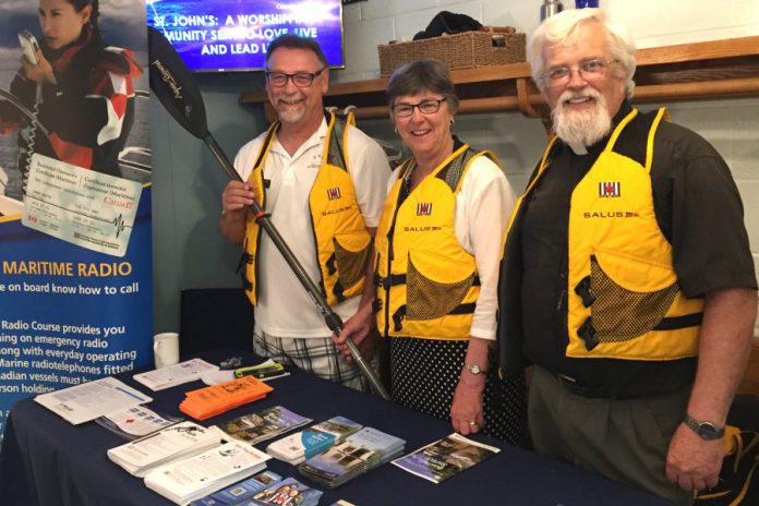 Among its activities, the Peterborough Power and Sail Squadron does educational outreach in the community. Pictured are squadrom members at an awareness and information booth at St. John's Anglican Church in Lakefield in June, which featured a special "Boaters Blessing" service.  (Photo courtesy of Peterborough Power and Sail Squadron)