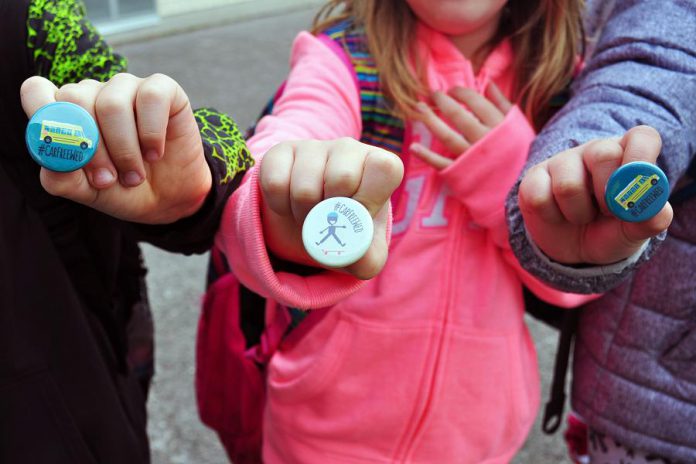 Kids show off their Car Free Wednesday buttons that were handed out last year at all schools participating in the program. Car Free Wednesdays encourages students to walk, bike, scoot or bus to school each Wednesday of the school year. (Supplied photo)