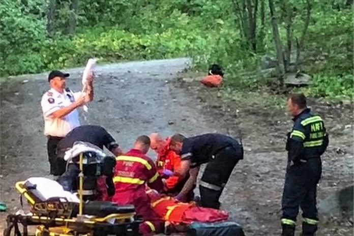 Barry Killen captured this scene of a rescue in Kawartha Highlands Provincial Park of a camper who was injured when a piece of equipment containing flammable liquid exploded at her remote campsite on Shark Lake. The woman, who suffered burns to areas of her body, was later airlifted by helicopter to Peterborough Regional Health Centre. (Photo: Barry Killen)