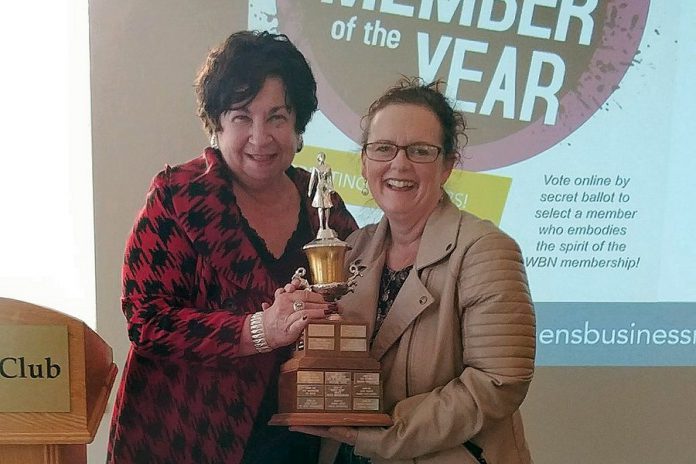 Maureen Tavener presents a "keeper version" of the 2018 Member of the Year Award to Tracey Ormond at the May 2018 meeting of the Women's Business Network of Peterborough. (Photo: Paula Kehoe / WBN)