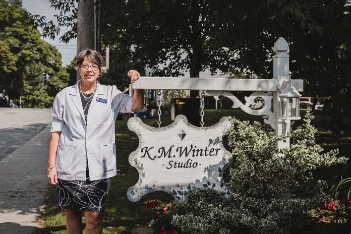 Kim Winter in front of her home-based studio in Peterborough. K.M. Winter Jewellery Studio supplies custom design and remodeling in gold, silver and platinum, engagement and wedding rings, jewellery appraisals and insurance replacement, jewellery repairs and lapidary, diamonds, colour stones, pearls, and opals. (Photo: Heather Doughty)