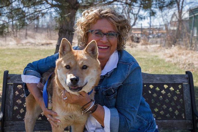 Susan with one of 15 dogs rescued from a Korean meat farm by Humane Society International and then made available for adoption. (Photo: Heather Doughty)