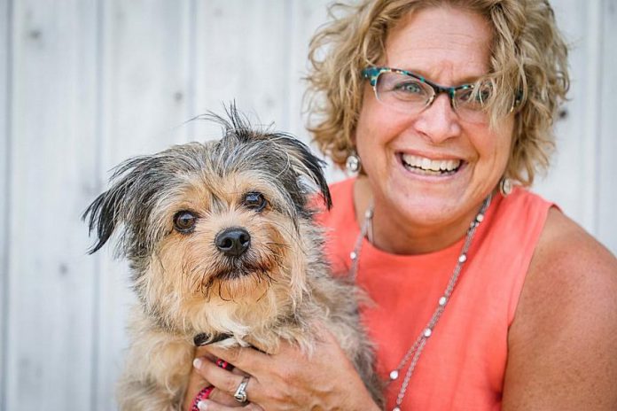 Susan Dunkley, Manager of Development and Outreach at the Peterborough Humane Society, with Chewy. A natural organizer, planner, and multitasker, Susan's high level of energy serves her well when working with the team at the Peterborough Humane Society as they work towards their making a state-of-the-art facility on Technology Drive a reality. (Photo: Heather Doughty)