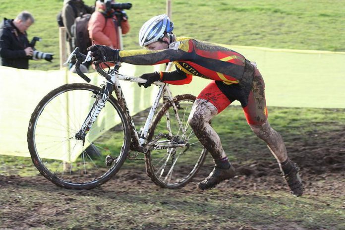 A cyclist navigates an obstacle during a cyclocross race in Abergavenny, Wales. A cyclocross course consists of many short laps on a course featuring pavement, wooded trails, grass, steep hills, and obstacles. Peterborough is hosting the Canadian championships in 2018 and again in 2019. (Photo: Ray Tyler / Flickr)