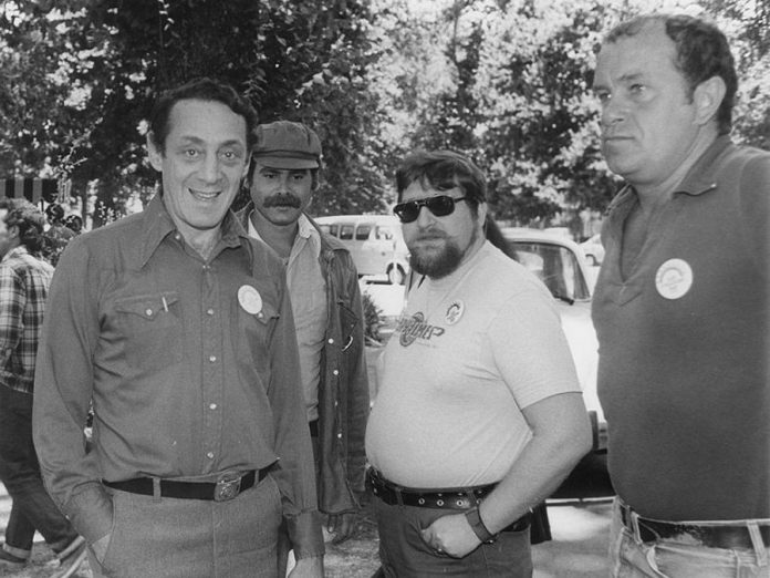 Demand for the rainbow flag greatly increased after the assassination of Harvey Milk (left, pictured at Gay Pride in San Jose in California in June 1978), the first openly gay elected official in the history of California. Milk, who was responsible for passing a stringent gay rights ordinance for San Francisco, served almost 11 months as a city supervisor when he and San Francisco Mayor George Moscone were shot and killed on November 27, 1978. Milk subsequently became an icon in San Francisco and a martyr in the gay community. (Photo: Wikipedia)