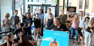 Peterborough DBIA executive director Terry Gueil (holding sign) announced the return of the Win This Space entrepreneurial competition for its third straight year in the lobby of the VentureNorth business hub in downtown Peterborough on September 18, 2018. The winner of the competition will win a free lease for a year of a vacant downtown storefront along with other prizes. (Photo courtesy of the Peterborough DBIA)