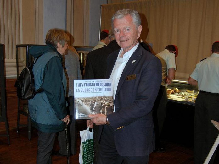 Port Hope Mayor Bob Sanderson at the opening ceremony of Armistice 18 on Sunday, September 30, 2018, with a copy of "They Fought In Colour", a new photographic exploration from The Vimy Foundation of Canada's First World War experience presented for the first time in full, vibrant colour, with commentary from some of Canada's leading public figures,  including Paul Gross, Peter Mansbridge, Margaret Atwood, Tim Cook, and many others. (Photo: April Potter / kawarthaNOW.com)