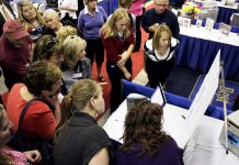 People gather around a display at Love Local Expo, the region's largest business trade show, in 2016. For the first time ever, this year's Love Local Expo takes place at the Evinrude Centre in Peterborough. Featuring more than 90 local businesses, Love Local Expo runs from noon to 7 p.m. on Wednesday, October 3, 2018. The event is free, there's lots of free parking, and there will be prizes including a notebook computer. (Photo: Peterborough Chamber of Commerce)