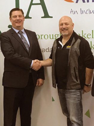  Michael Skinner, chancellor of the 2019 Junior Achievement of Peterborough Lakeland Muskoka Business Hall of Fame, thanks Brent Perry, president of Alf Curtis Home Improvements Inc., for the investment of $15,000. (Photo courtesy of JA-PLM)