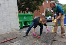 Volunteers remove pavement at the corner of Brock St. and Park St. in Peterborough, where a busy walkway in front of The Wine Shoppe on Park was transformed in 2016 from asphalt into a beautiful garden to divert 200 cubic meters of stormwater. GreenUP's fourth and largest Depave Paradise project will take place at the new Downtown Vibrancy Project site at the south end of Millennium Park, behind the No Frills parking lot, on October 11 and 12, 2018. (Photo: GreenUP)