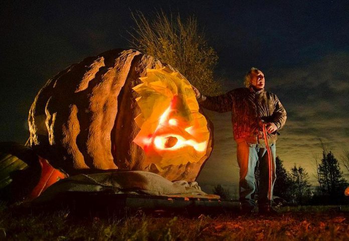 The giant jack-o'-lantern is on display in the front yard of the Hunts, located on Highway 35 near Cameron, north of Lindsay. The Hunts encourage people to stop by and take a picture with the pumpkin, which will be on display until mid November.  (Photo: Fred Thornhill Photography)