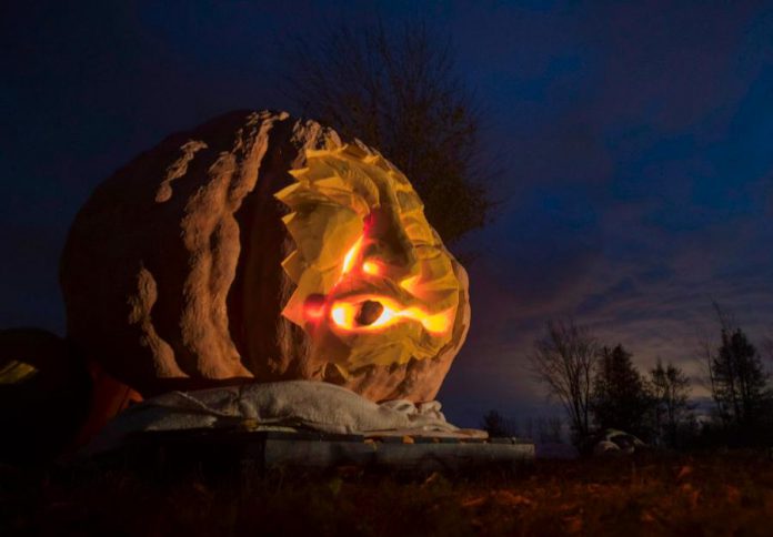 Fred Thornhill, a veteran photojournalist who resides near Bobcaygeon, took this photo of Canada's largest pumpkin, a 1,959-pound monster grown by Phil and Jane Hunt of Cameron, located north of Lindsay. Andrew Munro carved the pumpkin into a jack-o'-lantern, which is on display in the Hunts' front yard off Highway 35. (Photo: Fred Thornhill Photography)