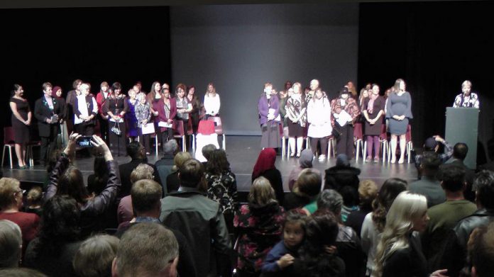 The award recipients gather on stage while emcee Gail Moorhouse addresses the crowd. (Photo: Bruce Head / kawarthaNOW.com)