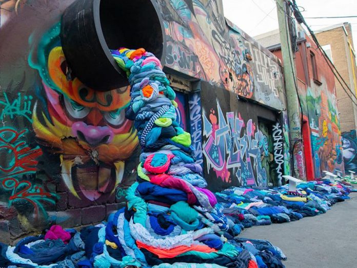 It takes 2,650 litres of water to produce a single cotton t-shirt, and Canadians throw away more than 12 million tonnes of clothing and textiles every year, 95 per cent of which could be reused or recycled. Pictured is part of an interactive art installation about textile waste in Graffiti Alley of Toronto’s Fashion District created by Value Village Thift Store for "Textile Tuesday" during Waste Reduction Week, which takes place until October 21st. (Photo: Value Village / Instagram)