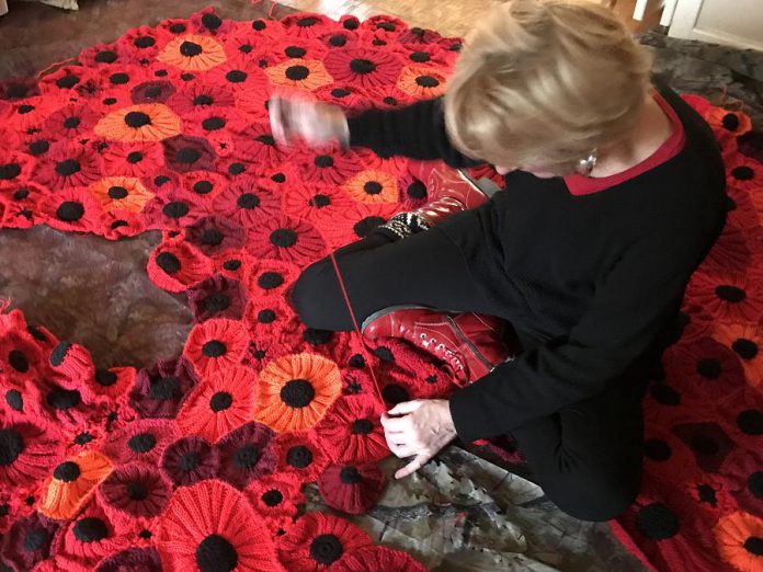 Hospice coordinator Heather Brough sews poppies together at the Hospice House for North Hastings in Bancroft. (Photo: Barb Shaw)