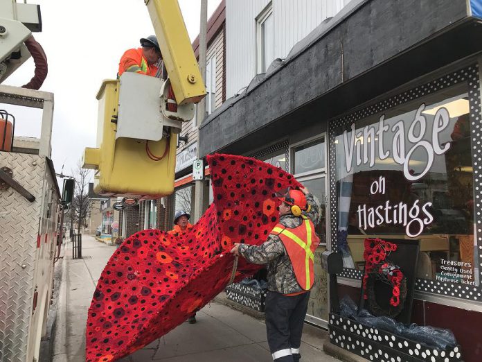 Employees with the public works department of the Town of Bancroft assisted with the installation of the mammoth poppy.  (Photo: Barb Shaw)