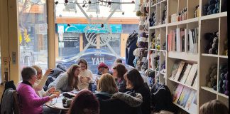 A group of knitters at Needles In The Hay in downtown Peterborough, one of the sponsors of the first-ever Community Knots Stitch-a-Thon, a fundraiser for the United Way of Peterborough & District and the Kawartha Sexual Assault Centre. On December 1, 2018, members of the crafting community are invited to fill 100 Lazy Boy Chairs at Bennett's Home Furnishings while working on projects to donate to local shelters. (Photo: Barb Shaw / kawarthaNOW.com)