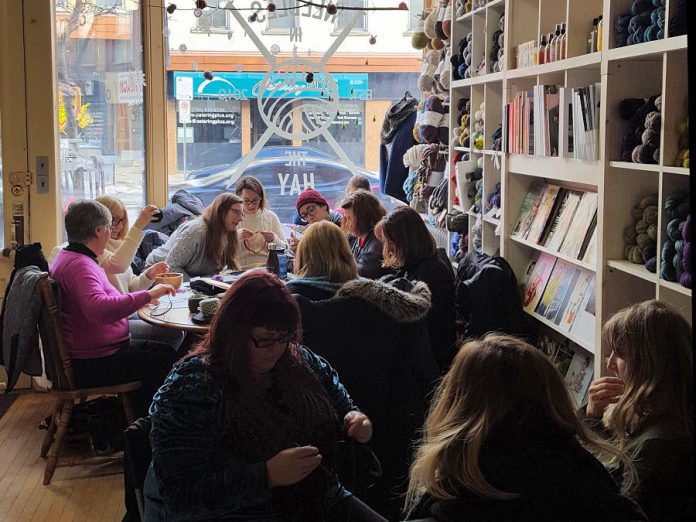 A group of knitters at Needles In The Hay in downtown Peterborough, one of the sponsors of the first-ever Community Knots Stitch-a-Thon, a fundraiser for the United Way of Peterborough & District and the Kawartha Sexual Assault Centre. On December 1, 2018, members of the crafting community are invited to fill 100 Lazy Boy Chairs at Bennett's Home Furnishings while working on projects to donate to local shelters. (Photo: Barb Shaw / kawarthaNOW.com)