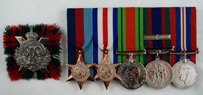 Joseph Sullivan's cap badge with tartan swatch, and medals: 1939-45 Star, France and Germany Star, Defence Medal, Canadian Volunteer Service Medal, and War Medal 1939-45. (Photo courtesy of Joseph Sullivan)