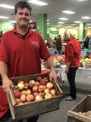 Brian Allin hauls crates of apples from Allin's Orchards to the winter location of the Peterborough Regional Farmers' Market in Peterborough Square. (Photo: Barb Shaw / kawarthaNOW.com)