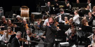 Maestro Michael Newnham leads the Peterborough Symphony Orchestra, the Kawartha Youth Orchestra, and audience members in the PSO's annual holiday carol sing-along in 2017. The Kawartha Youth Orchestra and the carol sing-along return in this year's holiday concert, "Home for the Holidays", which will be performed on Saturday, December 9th at Showplace Performance Centre in downtown Peterborough. (Photo: Huw Morgan)