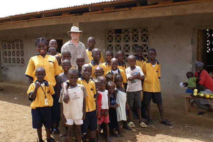 Peter Brown, Theresa Foley's parter in Humanwave.com, with students from a school in Liberia, West Africa. Humanwave.com has been sponsoring children at the school since 2007, and is currently sponsoring 13 students.  (Supplied photo)