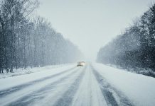 Cars on snow-covered highway.