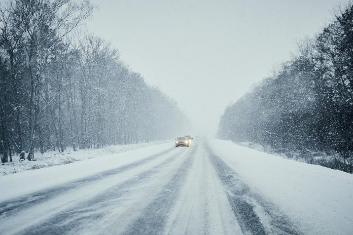 Cars on snow-covered highway.