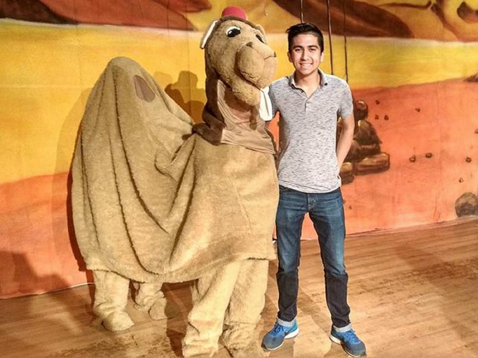 Alice the Camel with Toronto actor Armon Ghaeinizadeh, who plays Ali Baba, at a reherasal of "Ali Baba and the Forty Thieves", Globus Theatre's family panto version of the classic Middle Eastern folk tale. Written by Sarah Quick and also starring Sarah, James Barrett, Siobhan O'Malley, and a rotating cast of 50 children, the play runs from December 7 to 16, 2018 at the Lakeview Arts Barn in Bobcaygeon. (Photo: Sam Tweedle / kawarthaNOW.com)