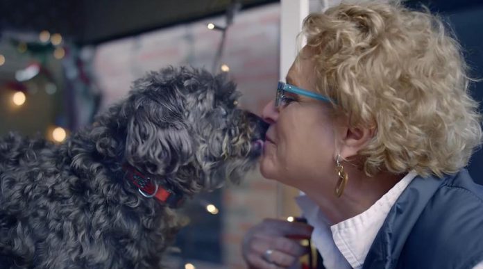 The Peterborough Humane Society's Susan Dunkley gets a kiss from her dog Zoey.  (Screenshot)