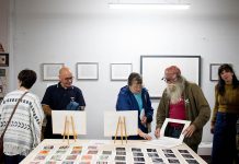 After the future of the event was thrown into question, a group of artists and organizations have come together to save the First Friday Art Crawl, which sees galleries and arts-based businesses in downtown Peterborough open their doors to the public at the same time on the first Friday evening of every month. Pictured is local artist Joe Stable (second from right), whose Acme Art & Sailboat Co. gallery on the third floor of the Commerce Building regularly participates in the event. (Photo: Peterborough DBIA)