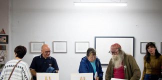 After the future of the event was thrown into question, a group of artists and organizations have come together to save the First Friday Art Crawl, which sees galleries and arts-based businesses in downtown Peterborough open their doors to the public at the same time on the first Friday evening of every month. Pictured is local artist Joe Stable (second from right), whose Acme Art & Sailboat Co. gallery on the third floor of the Commerce Building regularly participates in the event. (Photo: Peterborough DBIA)
