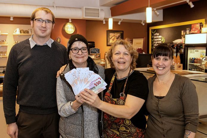 Avis Moores of Omemee (second from left) won the grand prize for Downtown Peterborough’s annual Holiday Shopping Passport program and picked up her prize of $1,500 in downtown money on January 11 at Simply Delicious at 197 Charlotte Street. Also pictured are Joel Wiebe of the Peterborough DBIA and Anita Morris and Barb Collins. (Photo courtesy of Peterborough DBIA) 