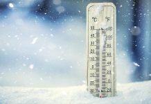 Extreme cold shown on thermometer in snow