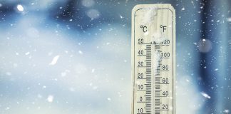 Extreme cold shown on thermometer in snow