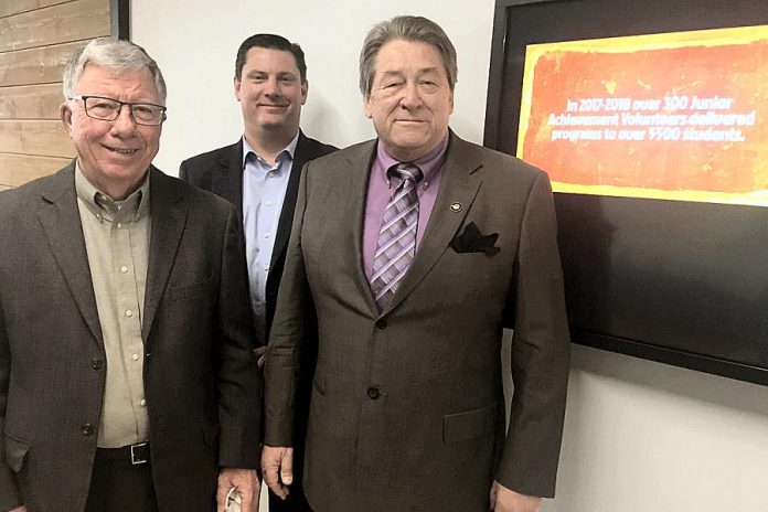 From left, Junior Achievement of Peterborough Lakefield Muskoka (JA-PLM) board chair Paul Ayotte, 2017 Business Hall of Fame inductee and JA-PLM Chancellor Michael Skinner, and JA-PLM president John McNutt pose by the touch-screen display that features profiles of each of the Hall of Fame inductees to date. It’s located near the lobby of the Venture North building in downtown Peterborough at George and King streets.  (Photo: Paul Rellinger / kawarthaNOW.com)